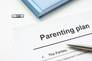 Parenting plan document and pen for signature.